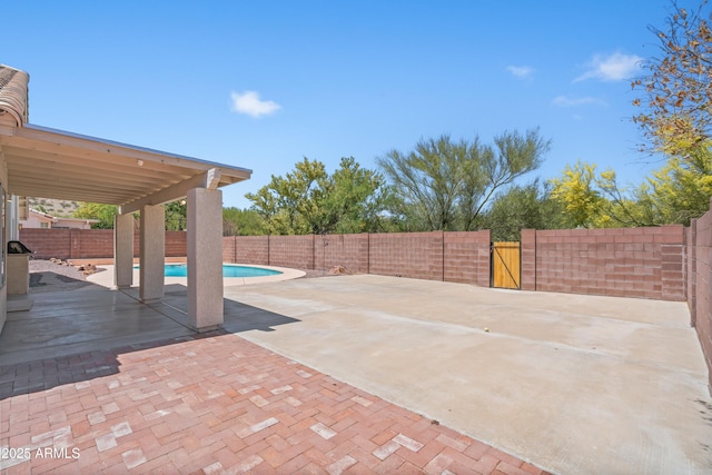view of patio featuring a fenced backyard, a gate, and a fenced in pool