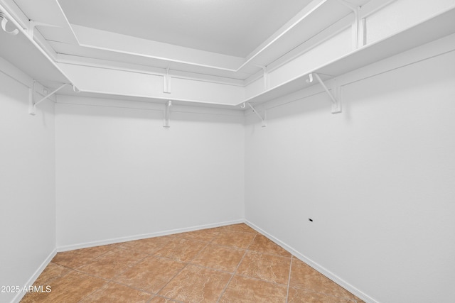 spacious closet with light tile patterned floors
