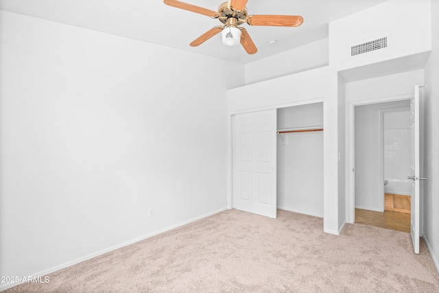 unfurnished bedroom with carpet flooring, a ceiling fan, baseboards, visible vents, and a closet