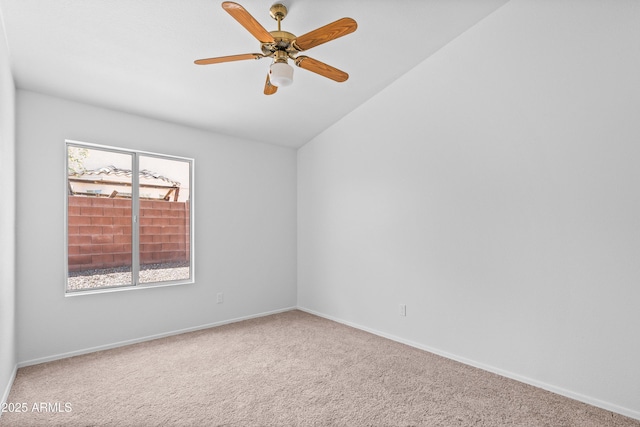 carpeted spare room with baseboards, a ceiling fan, and lofted ceiling