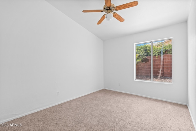 spare room with baseboards, carpet flooring, and lofted ceiling