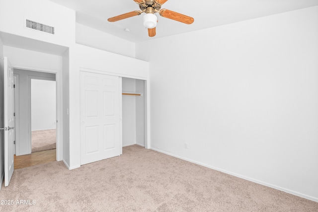 unfurnished bedroom featuring visible vents, baseboards, carpet floors, and a closet