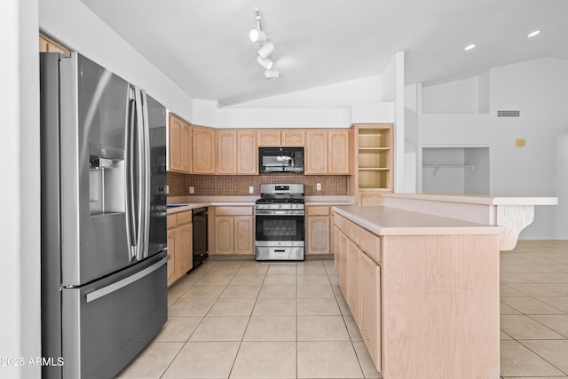 kitchen featuring light tile patterned floors, lofted ceiling, black appliances, and light brown cabinets