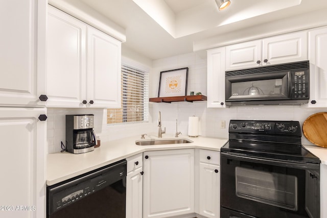 7008 E Gold Dust Ave Unit 236, Scottsdale, AZ 85253 - kitchen with black appliances, a sink, decorative backsplash, and white cabinetry
