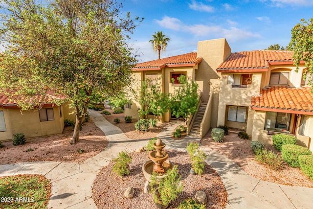 7008 E Gold Dust Ave Unit 236, Scottsdale, AZ 85253 - view of front of home featuring a tile roof, stucco siding, and stairway