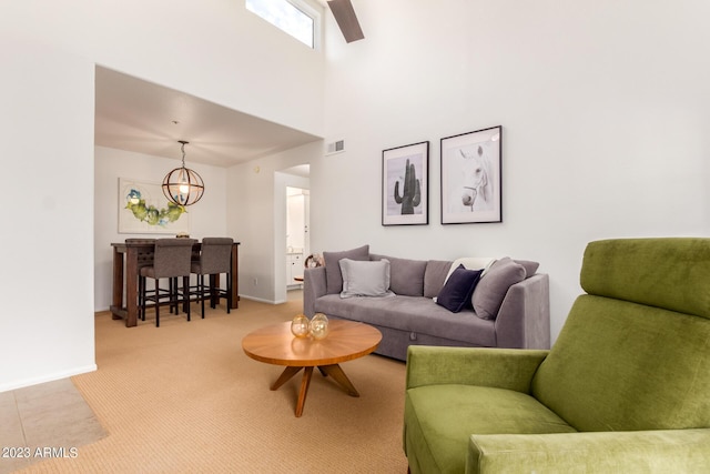 7008 E Gold Dust Ave Unit 236, Scottsdale, AZ 85253 - living area featuring carpet, a chandelier, baseboards, and a towering ceiling