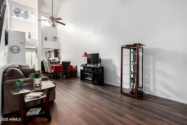 living room with dark hardwood / wood-style flooring, high vaulted ceiling, and ceiling fan