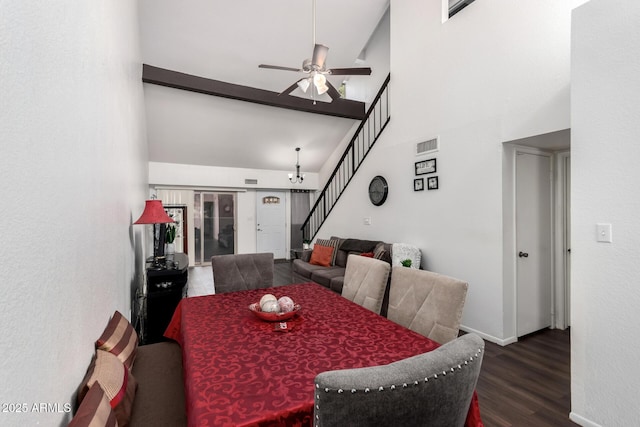 dining area featuring ceiling fan, dark hardwood / wood-style flooring, and a towering ceiling