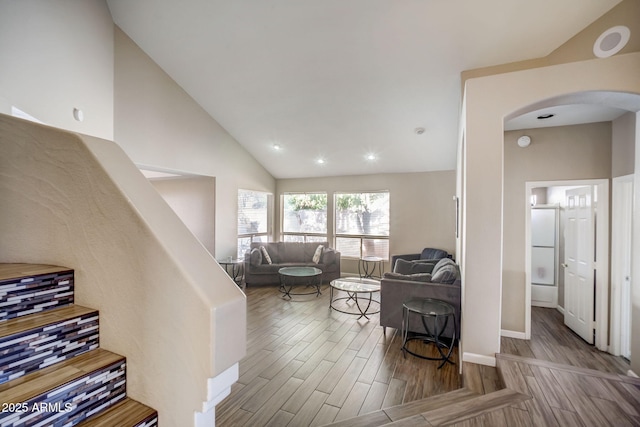 living room featuring lofted ceiling