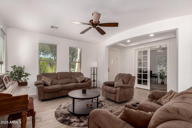 20409 W Thayer St, Buckeye, AZ 85396 - living room featuring arched walkways, ceiling fan, light wood-style flooring, and recessed lighting