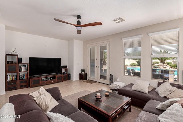20409 W Thayer St, Buckeye, AZ 85396 - living room featuring light tile patterned flooring, ceiling fan, and french doors