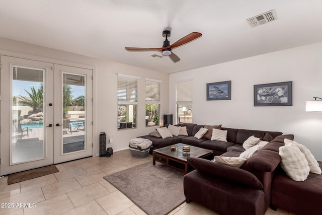 20409 W Thayer St, Buckeye, AZ 85396 - living room with french doors, a ceiling fan, and light tile patterned flooring