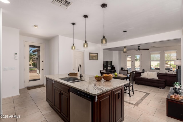 20409 W Thayer St, Buckeye, AZ 85396 - kitchen with stainless steel dishwasher, light tile patterned floors, a ceiling fan, dark brown cabinetry, and pendant lighting