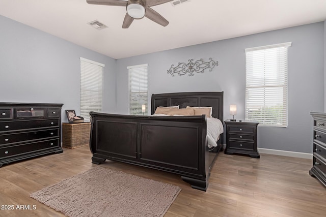 20409 W Thayer St, Buckeye, AZ 85396 - bedroom featuring multiple windows, light wood-type flooring, and a ceiling fan