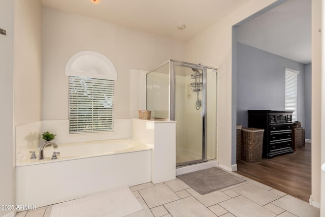 20409 W Thayer St, Buckeye, AZ 85396 - bathroom with a shower stall, a garden tub, and tile patterned flooring