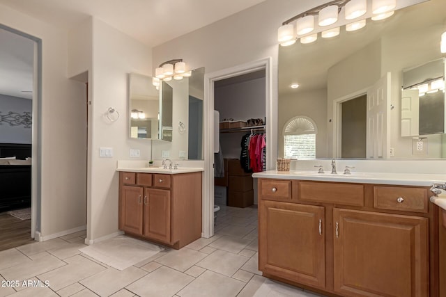 20409 W Thayer St, Buckeye, AZ 85396 - full bath featuring two vanities, a spacious closet, and tile patterned flooring