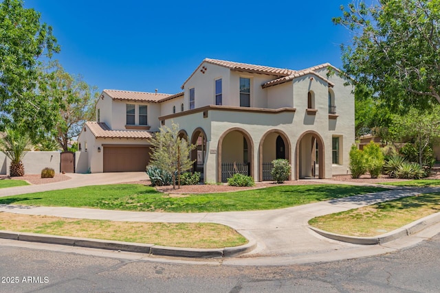 20409 W Thayer St, Buckeye, AZ 85396 - mediterranean / spanish house featuring a tiled roof, stucco siding, concrete driveway, an attached garage, and a porch