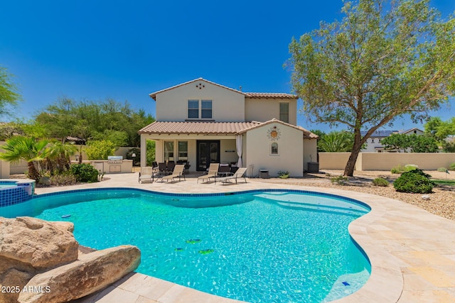 20409 W Thayer St, Buckeye, AZ 85396 - view of swimming pool featuring exterior kitchen, a patio area, and a pool with connected hot tub