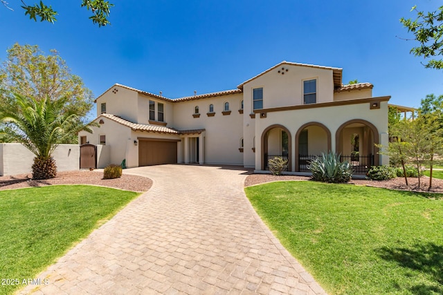 20409 W Thayer St, Buckeye, AZ 85396 - mediterranean / spanish-style home with stucco siding, a tiled roof, decorative driveway, an attached garage, and a gate
