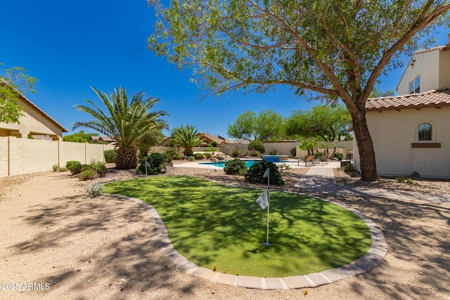 20409 W Thayer St, Buckeye, AZ 85396 - fenced backyard featuring a putting area and a patio