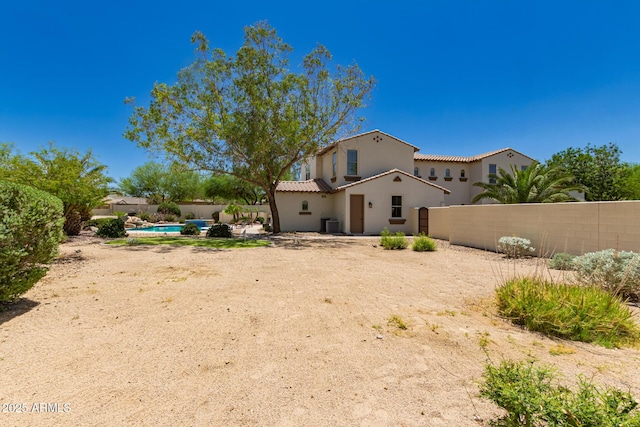 20409 W Thayer St, Buckeye, AZ 85396 - rear view of property featuring a fenced backyard, stucco siding, a tiled roof, and a patio
