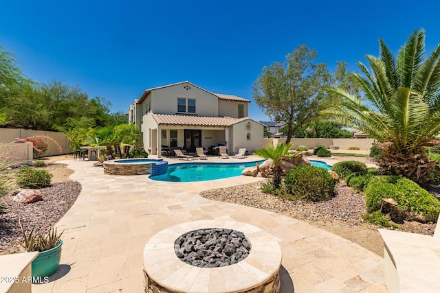 20409 W Thayer St, Buckeye, AZ 85396 - view of swimming pool featuring a fire pit, a patio area, a fenced backyard, and a pool with connected hot tub