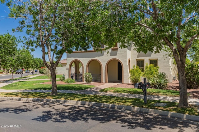 20409 W Thayer St, Buckeye, AZ 85396 - mediterranean / spanish home featuring stucco siding and a front lawn