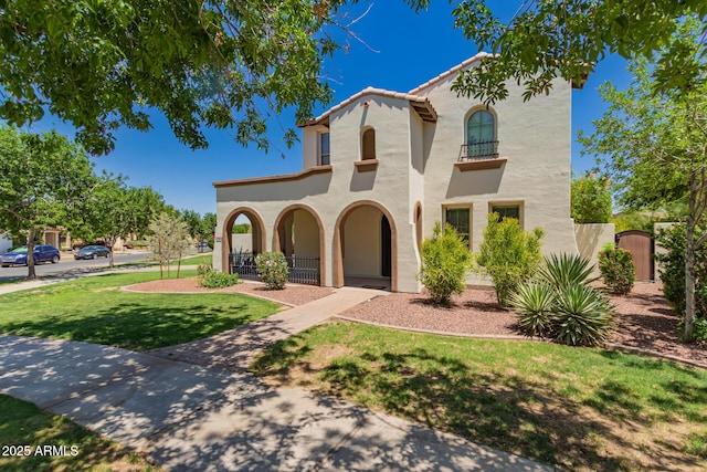 20409 W Thayer St, Buckeye, AZ 85396 - mediterranean / spanish-style house featuring stucco siding and a front yard