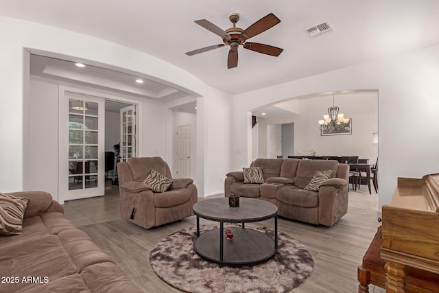 20409 W Thayer St, Buckeye, AZ 85396 - living area with arched walkways, a chandelier, a ceiling fan, light wood-style flooring, and recessed lighting