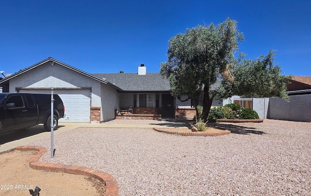 ranch-style house featuring brick siding, an attached garage, a chimney, concrete driveway, and fence