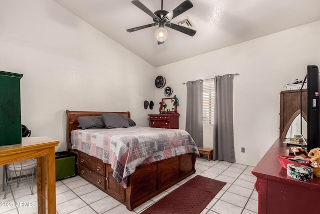 bedroom with vaulted ceiling, light tile patterned floors, and a ceiling fan