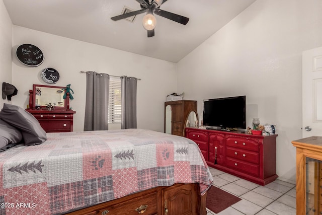 bedroom with vaulted ceiling, light tile patterned flooring, and ceiling fan