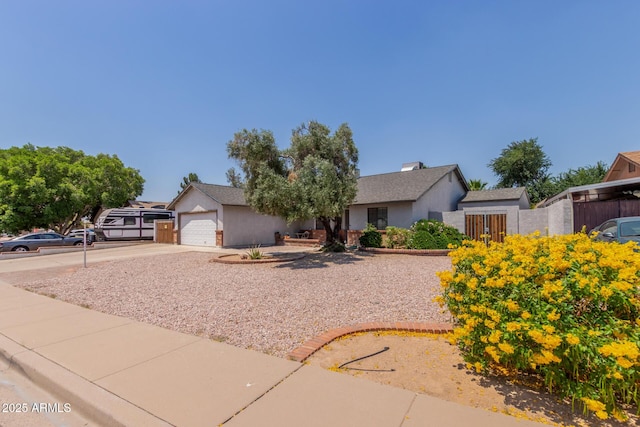 ranch-style house with driveway, stucco siding, and a garage