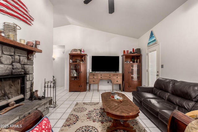 living room featuring light tile patterned flooring, vaulted ceiling, ceiling fan, and a fireplace