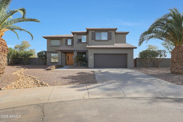 view of front of property with a garage, concrete driveway, fence, and stucco siding