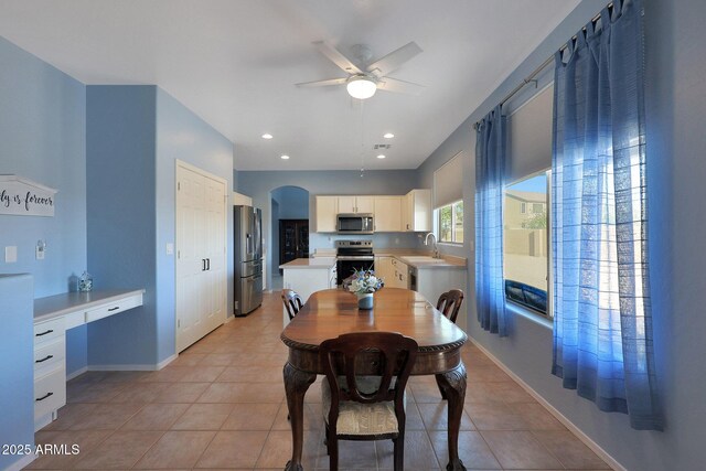 6993 S Sharon Ct, Chandler, AZ 85249 - dining room with arched walkways, light tile patterned floors, baseboards, and a ceiling fan