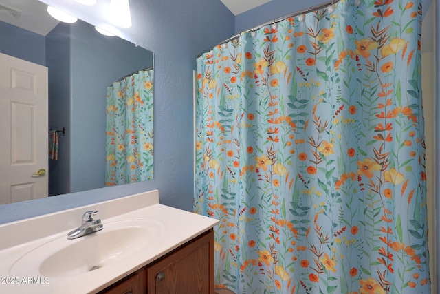 6993 S Sharon Ct, Chandler, AZ 85249 - full bathroom with visible vents, a shower with shower curtain, vanity, and a textured wall