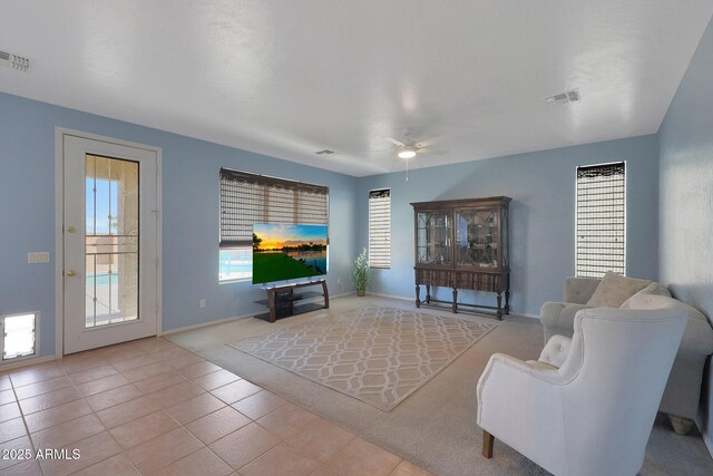 6993 S Sharon Ct, Chandler, AZ 85249 - living area with light carpet, visible vents, baseboards, and ceiling fan