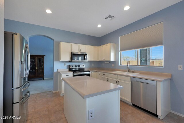 6993 S Sharon Ct, Chandler, AZ 85249 - kitchen featuring arched walkways, visible vents, light countertops, a sink, and stainless steel appliances
