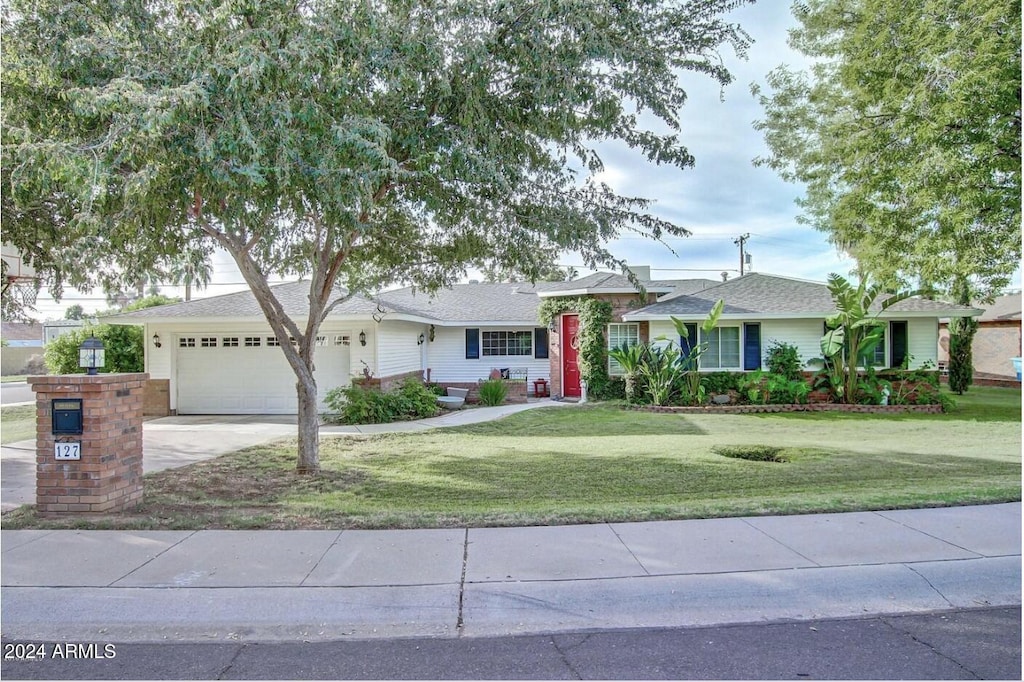 ranch-style house with a front lawn and a garage