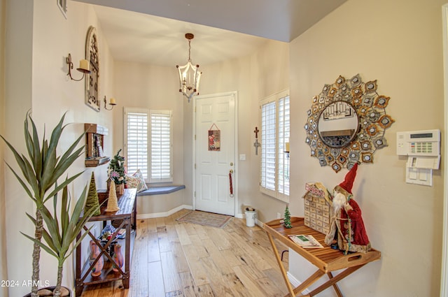 foyer featuring a notable chandelier and light wood-type flooring