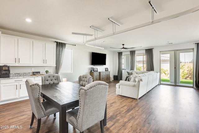 dining room featuring dark wood finished floors and a ceiling fan