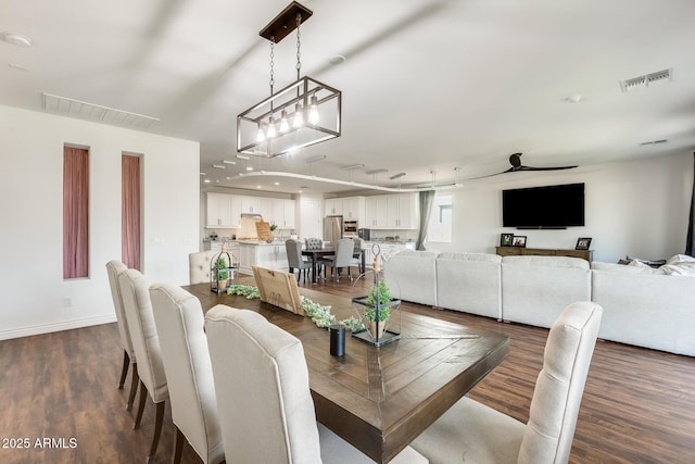 dining space featuring visible vents, dark wood finished floors, baseboards, and ceiling fan