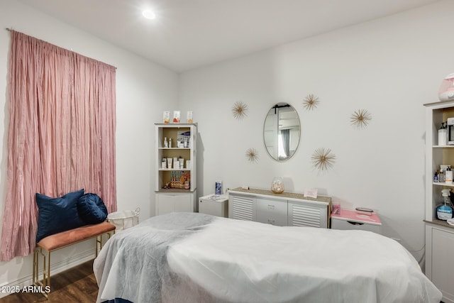 bedroom with dark wood-style flooring