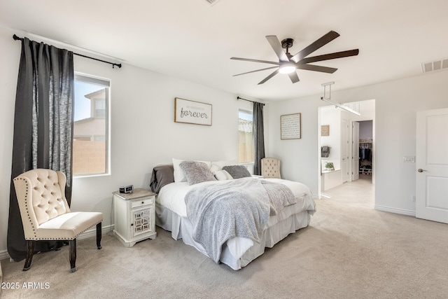 bedroom with light colored carpet, visible vents, baseboards, and multiple windows