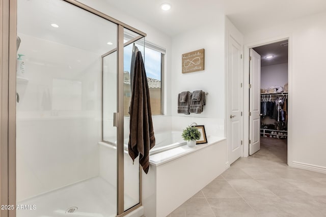 full bathroom with tile patterned flooring, recessed lighting, a spacious closet, a bath, and a stall shower