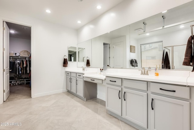 full bath with a walk in closet, recessed lighting, a stall shower, vanity, and baseboards