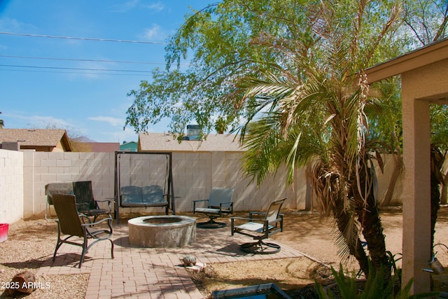 view of patio featuring a fire pit and a fenced backyard