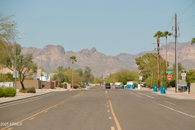 view of street featuring a mountain view and traffic signs