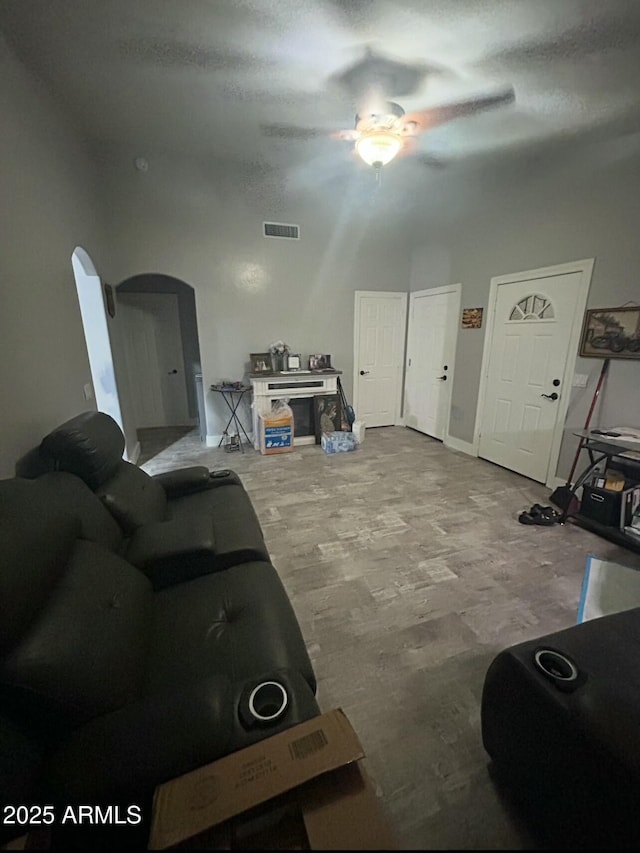 living area featuring arched walkways and visible vents